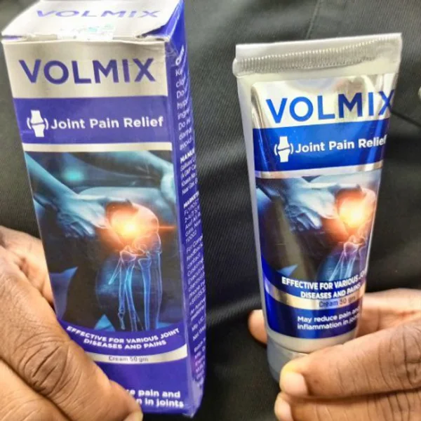 Hands holding the Volmix box and cream tube received at home
